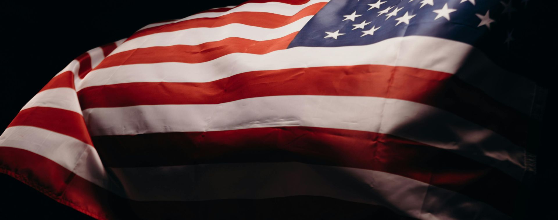 Close-up of a wind-blown American flag symbolizing freedom and patriotism.